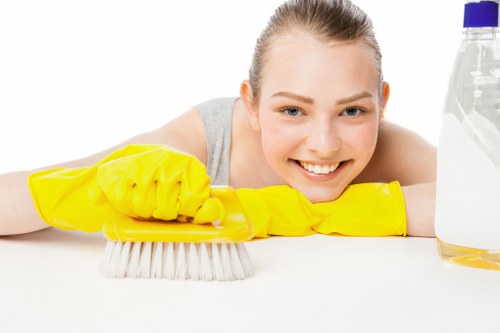 Cleaner maintaining desks and communal areas in a Haringey office