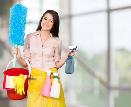 Professional cleaner maintaining a Haringey bathroom and hallway